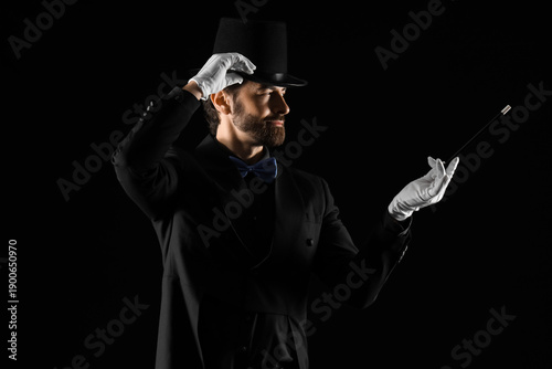 Male magician with wand on ...