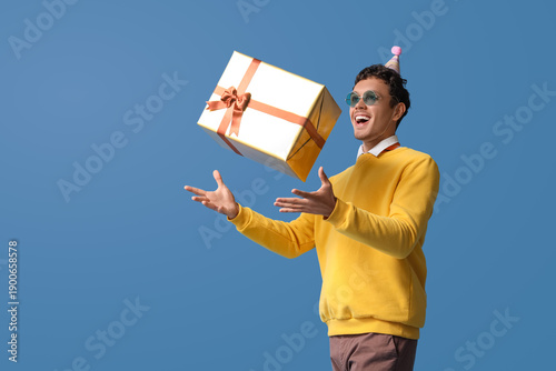Happy young man throwing Bi...