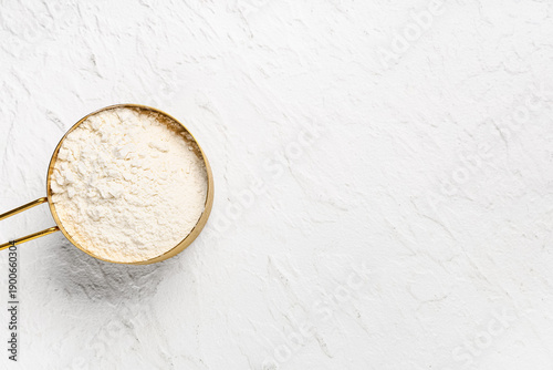 Measuring cup with flour on...