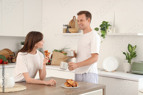Young couple with cups of t...