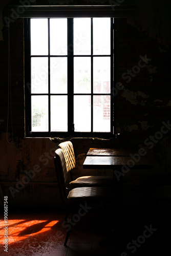 A quiet moment bathed in warm sunlight, casting shadows of solitude through an old window.