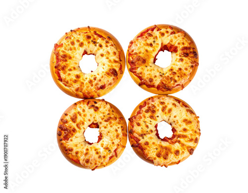 Four baked pizza-bagels arranged in a square, top-down view