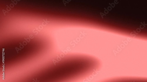A close-up of a smooth gradient with dark upper section and pink lower section