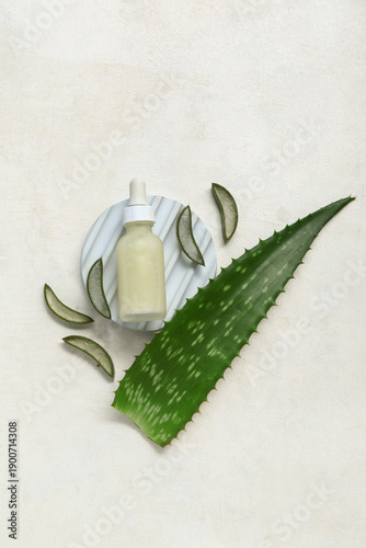 Fresh aloe leaf with bottle...