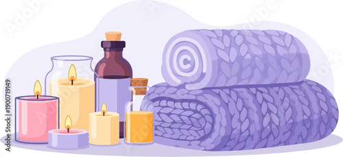 Spa accessories lit candles, essential oil bottles, and folded plush towels