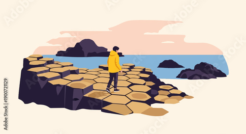 Person in yellow jacket walks on hexagonal stones by the sea