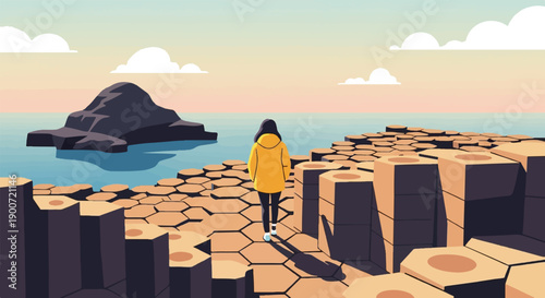 Person in yellow jacket walks on hexagonal rock formations by the sea