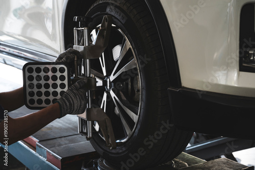 Car wheel alignment services in garage service shop.	