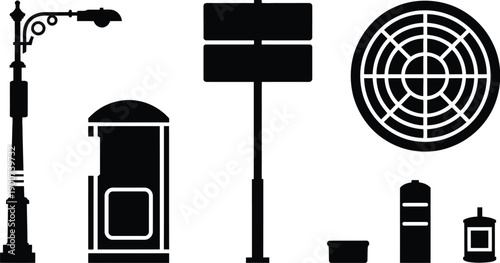 Black silhouettes of urban street furniture including lamp post and manhole cover