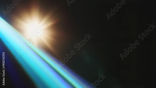 Bright central light with blue lens flares and rays on black background. Slow motion animation of glowing sun effect. Digital visual overlay for cinematic videos and graphic design
