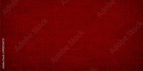 A vintage red grunge canvas background features an aged linen fabric texture with a dark antique paper pattern and distressed textile material for a blank textured wallpaper backdrop