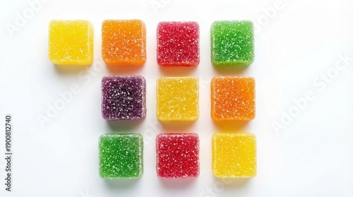 Colorful sugar-coated jelly candies arranged in neat grid on white background, bright lighting, minimal composition, vibrant translucent textures, playful confectionery flat lay photography.
