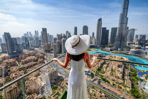 Photography A elegant luxury woman with a white hat enjoys the panoramic view over the Downt