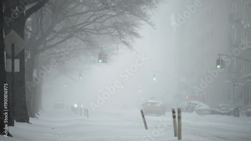 Traffic moving cautiously on New York City avenue during heavy snow
