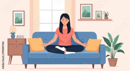 Woman meditating peacefully on a blue couch in a cozy room
