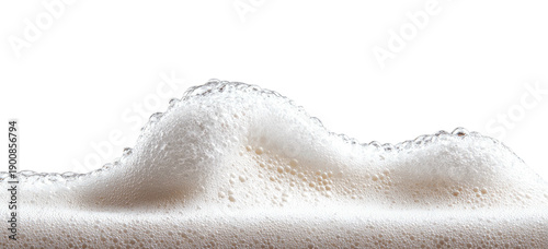 Close-up of frothy, off-white foam with a wave-like structure against a black background