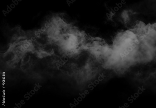 Misty clouds float against dark mysterious foggy background