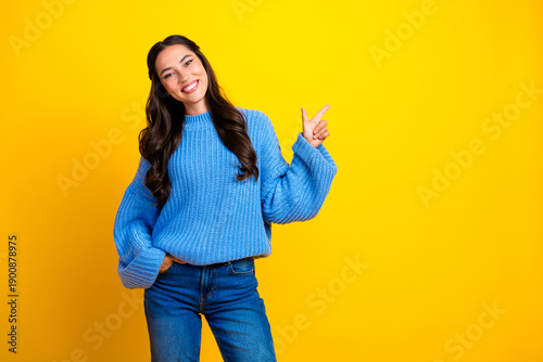 Cuadro en lienzo Young mixed race woman in blue sweater smiling pose against bright yellow backgr