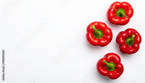 Vibrant Red Bell Peppers on Clean White Surface with Natural Lighting