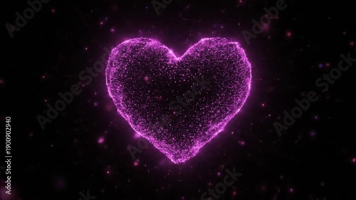 A stunning video of a pink heart shape made of tiny particles on a black background
