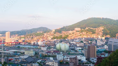 Nagasaki, Japan. Aerial timelapse made from a hill in Nagasaki, Japan, with a view over the entire center, including the bay and the hills. Cloudy and sunny day in summer, apnning video