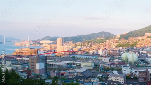 Nagasaki, Japan. Aerial timelapse made from a hill in Nagasaki, Japan, with a view over the entire center, including the bay and the hills. Cloudy and sunny day in summer