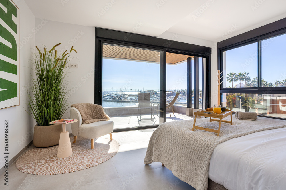 Fototapeta premium Coastal bedroom with terrace access and panoramic marina view