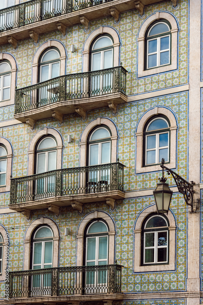 Obraz premium Traditional Portuguese Building Facade with Ornate Azulejo Tiles and Wrought Iron Balconies, Lisbon, Portugal.