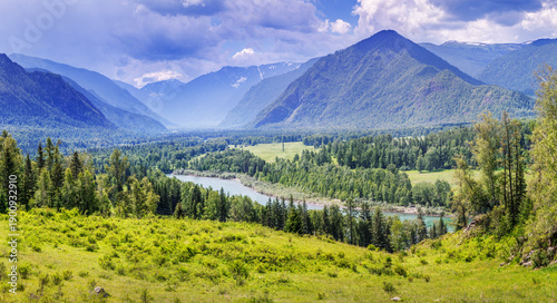 Принти на полотні A picturesque mountain valley with a river, summer greenery of meadows and fores