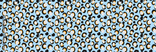 Seamless vector leopard pattern with playful abstract animal spots in black, white and warm yellow on a light blue background. Bold modern wild texture for fashion, textiles, wallpaper and packaging