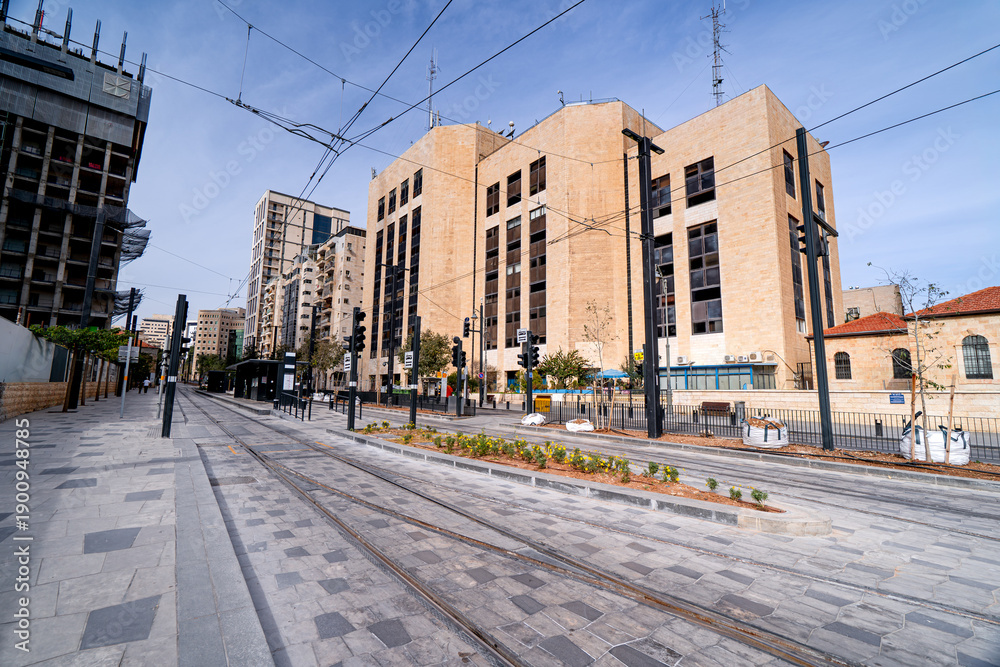 Fototapeta premium Tram stop in the center of modern district in Jerusalem with skyscrapers, Israel.