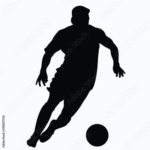 silhouette of a soccer player kicking the ball