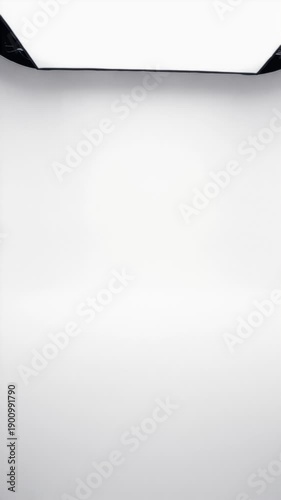 Muted, clean, empty photography studio interior with bright white walls and floor.