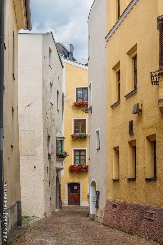 Fototapeta premium Narrow Cobblestone Street in the Medieval Old Town of Hall in Tirol, Austria