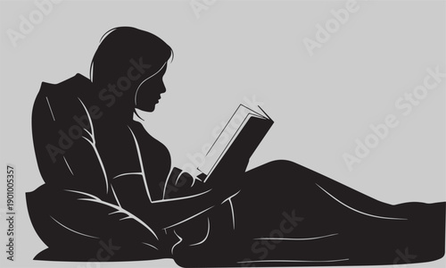 Silhouette of a Young Woman Reading a Book in Bed