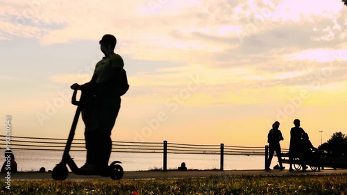 2 Clips: Silhouettes of people walking along the seashore. 