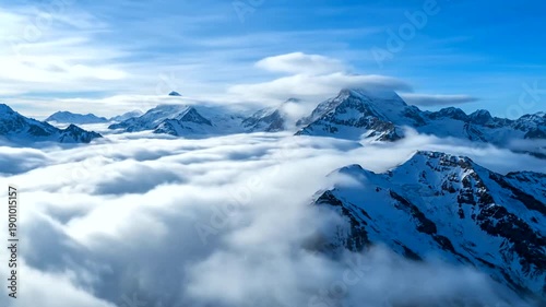 Snowcapped Mountains Above the Clouds Aerial View.