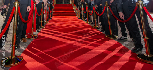 Abstract blurred background with red carpet and celebrities