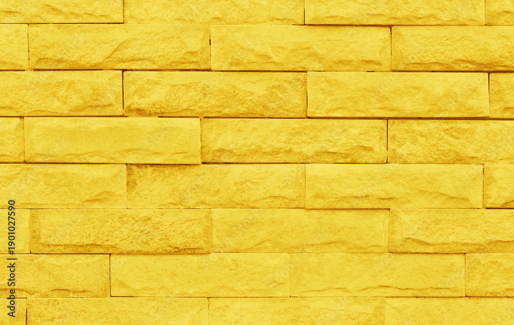 Obraz premium Golden yellow brick wall texture with vintage style pattern for background and design art work.
