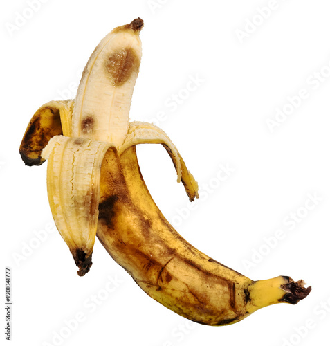 Fotografija A rotten banana in its peel on a white background