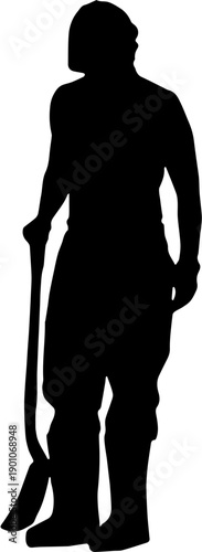 Silhouette of a construction laborer or gardener standing with a shovel