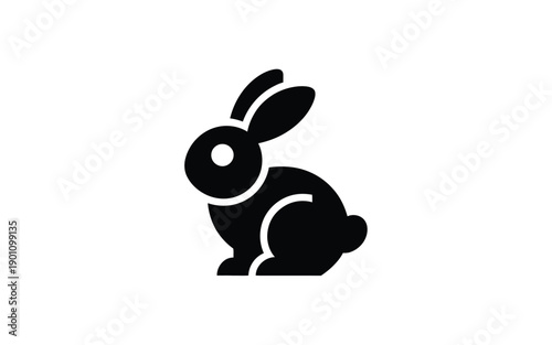 Black silhouette rabbit icon sitting on white background with long ears