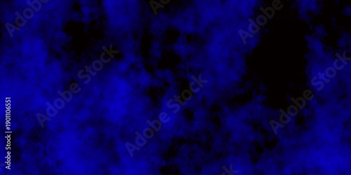 
Artificial magic smoke in black and blue light on black background in darkness. light blue and dark blue background. Black and blue Grunge Concrete Wall Texture Background.

