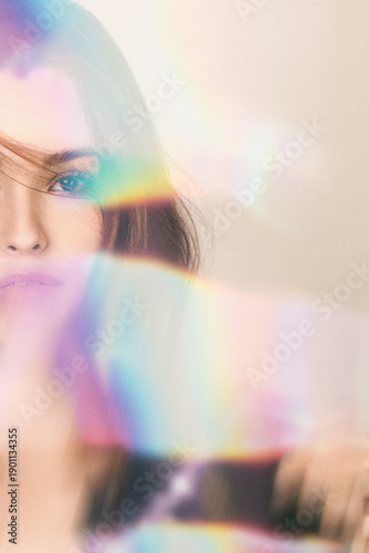 Woman's portrait with soft focus and ethereal light leaks creating a dreamy atmosphere