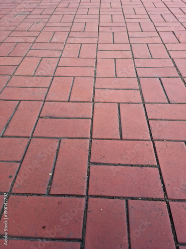 It is a red sidewalk block floor.