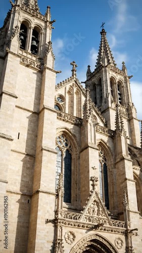 A detailed low-angle shot of a magnificent Gothic cathedral, bathed in warm sunlight. Perfect for content on travel, history, architecture, or religio