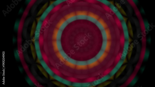 A vibrant, swirling pattern of concentric circles in deep hues of red, green, and yellow