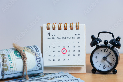 Tax Day Concept with April 15 Calendar and Cash Bundles for Financial Planning and Accountability