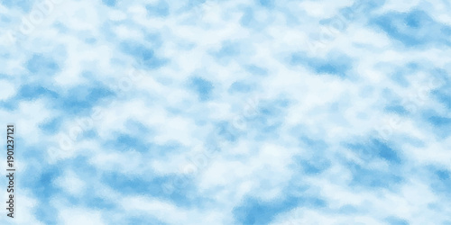 A beautiful clear blue sky features bright white fluffy cumulus clouds floating through a natural summer atmosphere on a light sunny day