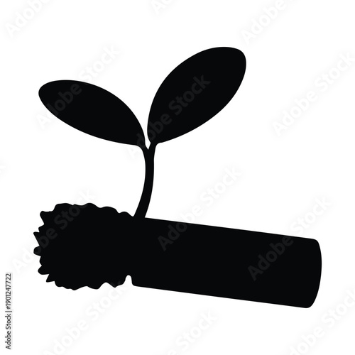 Sprouting seedling emerging from soil with two leaves growing